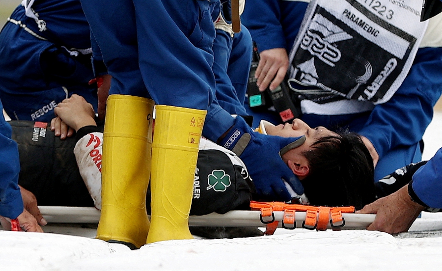 Alfa Romeo's Guanyu Zhou receives medical treatment after crashing out at the start of the race. (Photo by REUTERS/Molly Darlington) MOLLY DARLINGTON