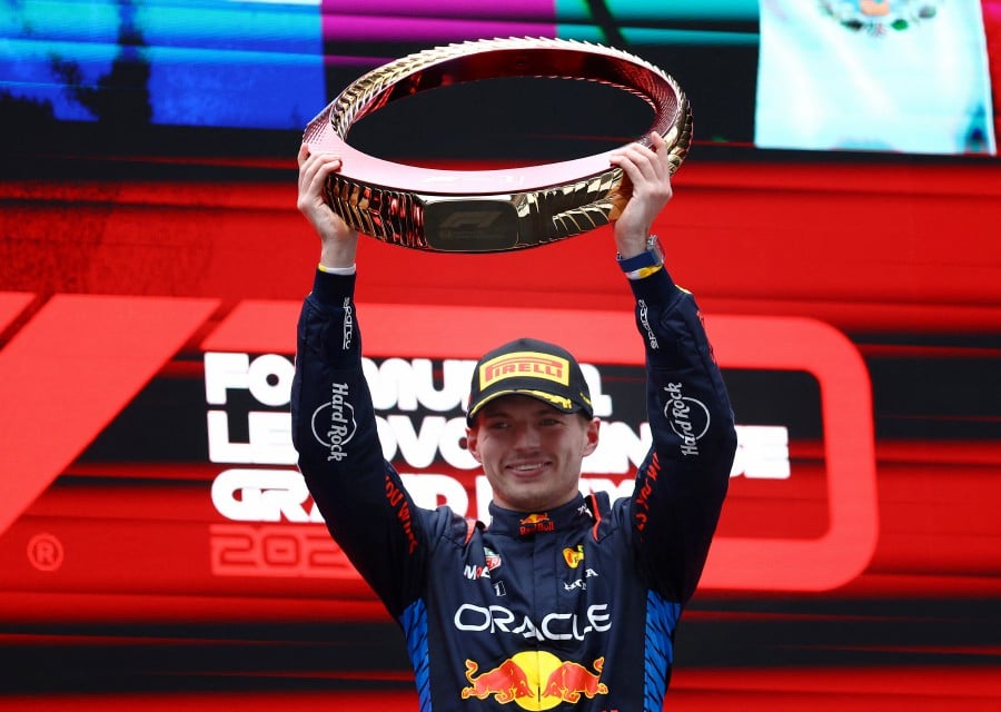 Chinese Grand Prix - Shanghai International Circuit, Shanghai, China - Red Bull's Max Verstappen celebrates with the trophy on the podium after winning the Chinese Grand Prix.- Reuters pic