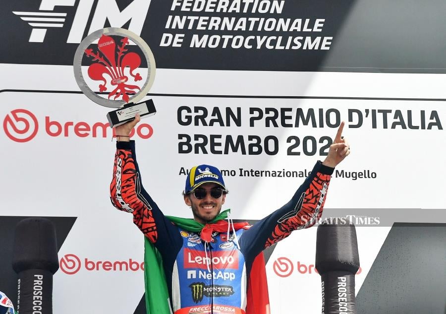 Ducati Lenovo Team's Francesco Bagnaia celebrates with a trophy on the podium after winning the Italian Grand Prix at Mugello Circuit, Scarperia e San Piero, Italy. REUTERS PIC 