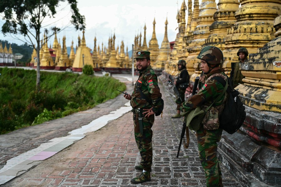 Members of ethnic minority armed group Ta'ang National Liberation Army (TNLA) standing guard in a temple area of a hill camp seized from Myanmar's military in Namhsan Township in Myanmar's northern Shan State. Ethnic minority fighters battling Myanmar's junta said December 16 they seized a trading hub in Shan state, days after China said it had mediated a temporary ceasefire. AFP PIC