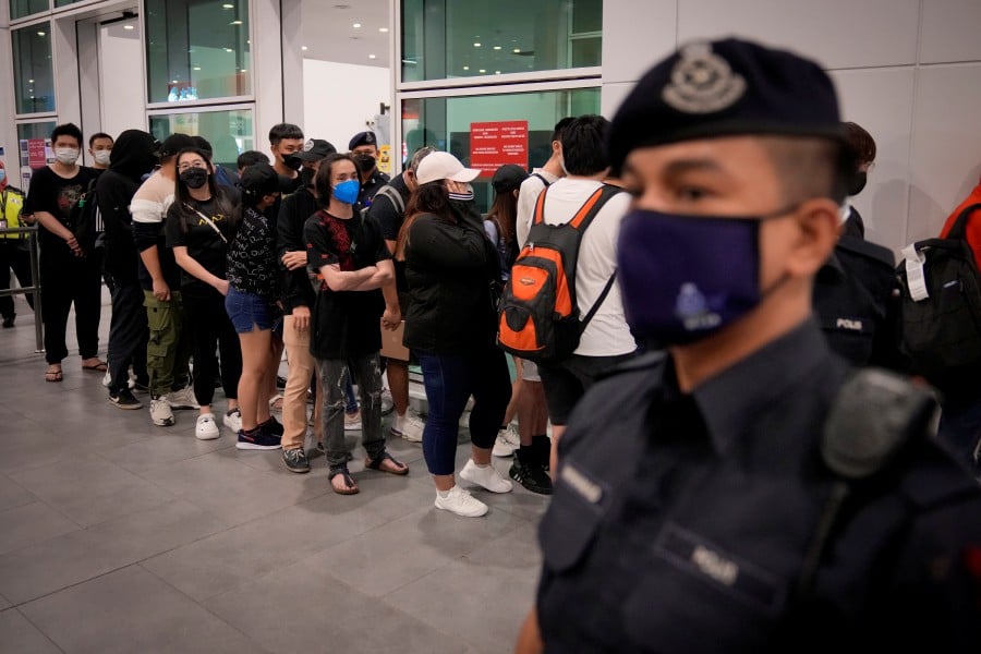 Malaysian youths rescued from human traffickers in Cambodia arrive at the Kuala Lumpur Airport Terminal in Sepang. -AP PIC