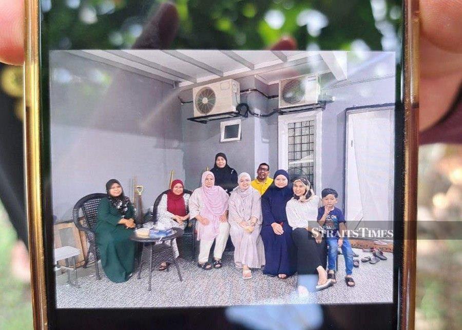 Manirah Rafiee (wearing black at the back) who was found dead on a prayer mat at her home in Taman Inang, Mergong last night. - NSTP/ZULIATY ZULKIFFLI