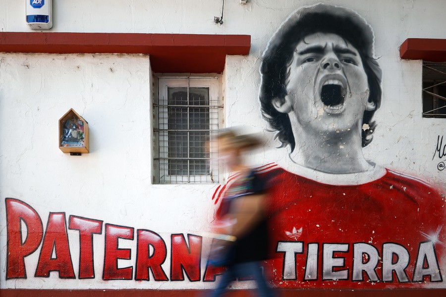 epaselect epa0960063 A person walks past a mural in tribute to the late Argentine former soccer player Diego Armando Maradona ahead of the first anniversary of his death in Buenos Aires, Argentina. - EPA PIC