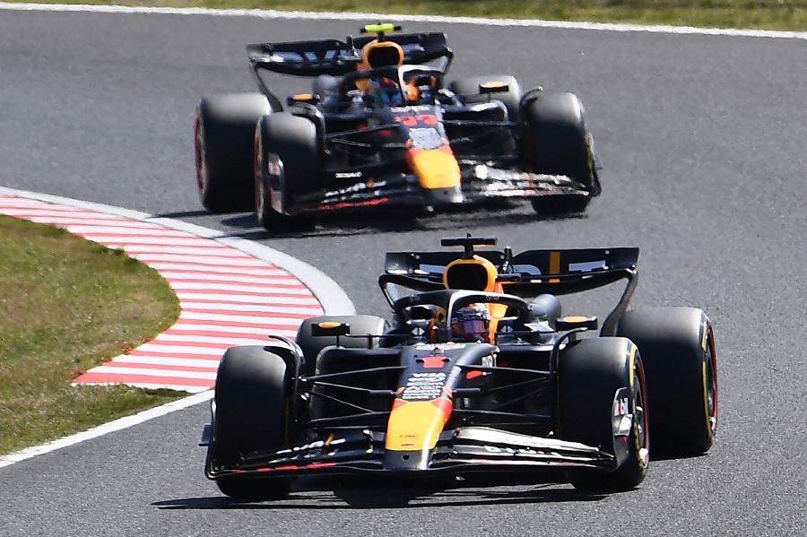 Red Bull Racing's Dutch driver Max Verstappen (front) takes a turn ahead of Red Bull Racing's Mexican driver Sergio Perez (behind) at the start of the Formula One Japanese Grand Prix race at the Suzuka circuit in Suzuka, Mie prefecture on. - AFP pic