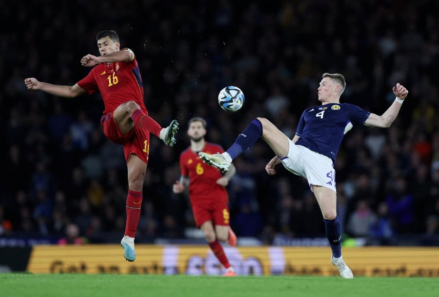 Spain's Rodri in action with Scotland's Scott McTominay. (REUTERS/Russell Cheyne)