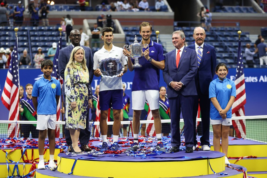  Novak Djokovic of Serbia holds the runner-up trophy alongside Daniil Medvedev of Russia who celebrates with the championship trophy after winning their Men's Singles final match on Day Fourteen of the 2021 US Open at the USTA Billie Jean King National Tennis Center in the Flushing neighbourhood of the Queens borough of New York City. - AFP PIC