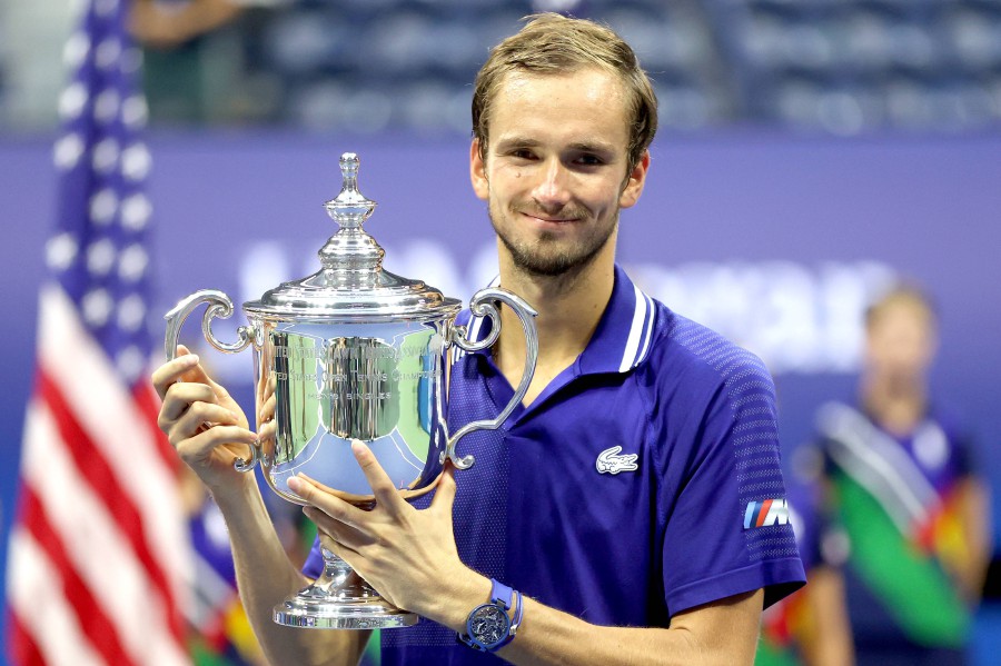  Daniil Medvedev of Russia celebrates with the championship trophy after defeating Novak Djokovic of Serbia to win the Men's Singles final match on Day Fourteen of the 2021 US Open at the USTA Billie Jean King National Tennis Center in the Flushing neighbourhood of the Queens borough of New York City. - AFP PIC