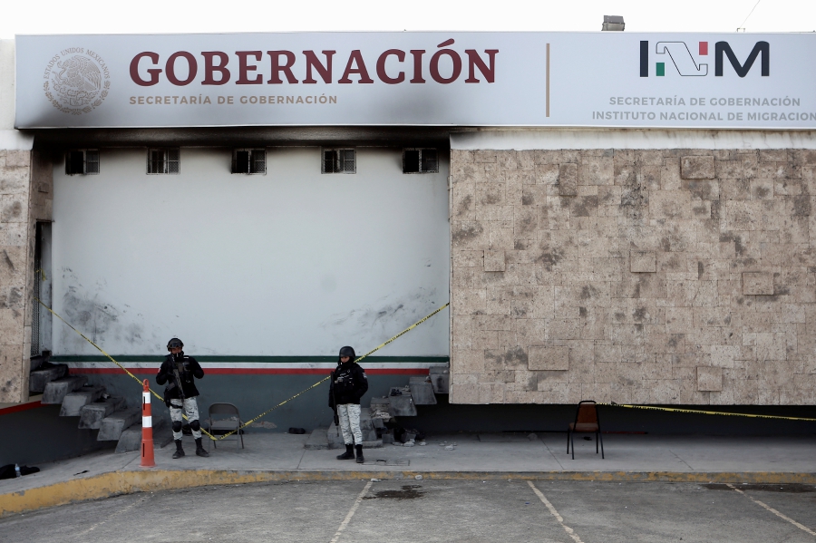 Police stand guard outside a Mexican immigration detention center in Ciudad Juarez, Mexico. (AP Photo/Christian Chavez)