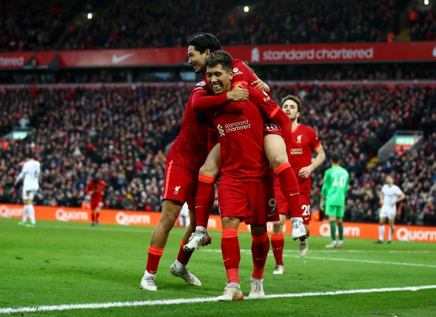Liverpool's Takumi Minamino (up) celebrates with teammates after scoring the 3-0 lead against Brentford at Anfield in Liverpool. -EPA PIC