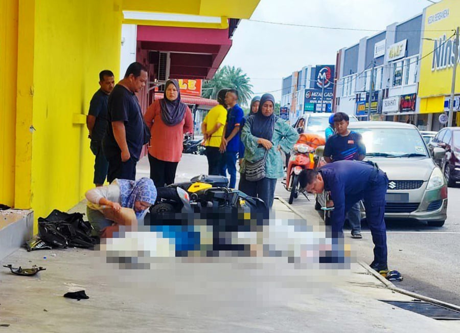 A teenage girl was killed and her friend seriously injured after the motorcycle they were riding skidded and hit a wall of a supermarket in Taman Serai Wangi, Padang Serai here, this afternoon. - Pic courtesy from Reader