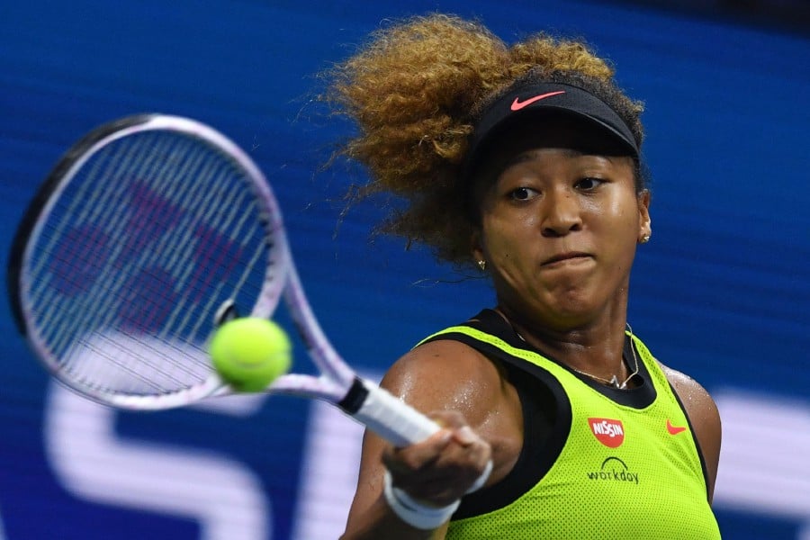 Japan's Naomi Osaka hits a return to Czech Republic's Marie Bouzkova during their 2021 US Open Tennis tournament women's singles first round match at the USTA Billie Jean King National Tennis Center in New York, on August 30, 2021. (Photo by Ed JONES / AFP)