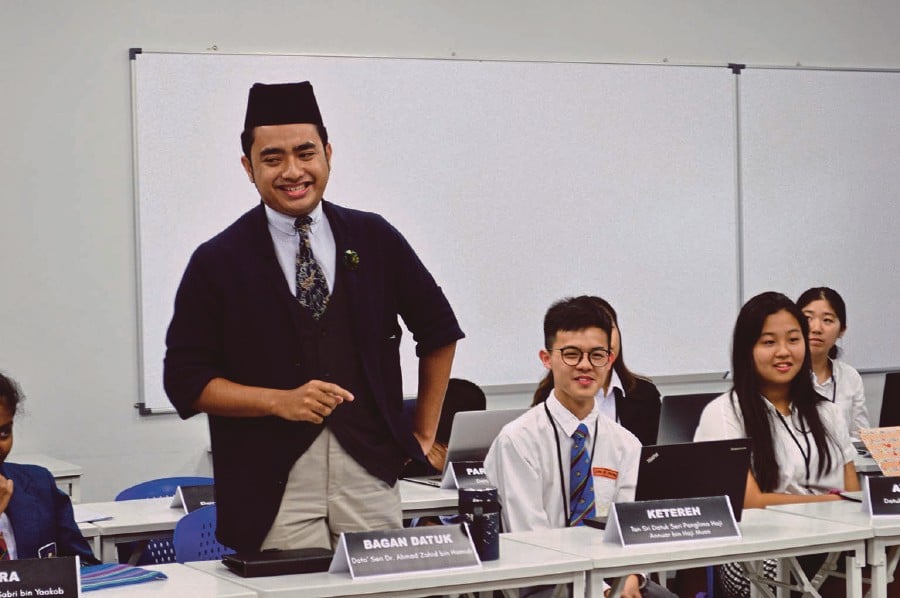 International Islamic University Malaysia student Shah Nizam Mazlan (left) with other delegates of the simulated Dewan Rakyat debating on important Malaysian issues.
