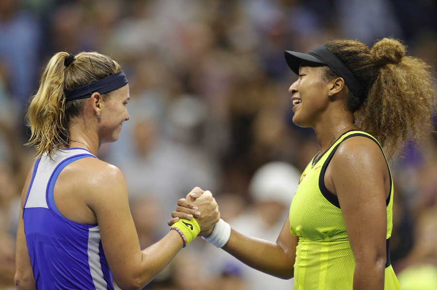 Naomi Osaka (R) of Japan shakes hands with Marie Bouzkova (L) of the Czech Republic after winning during their Women's Singles first round match on Day One of the 2021 US Open at the Billie Jean King National Tennis Center on August 30, 2021 in the Flushing neighborhood of the Queens borough of New York City. - Sarah Stier/Getty Images/AFP