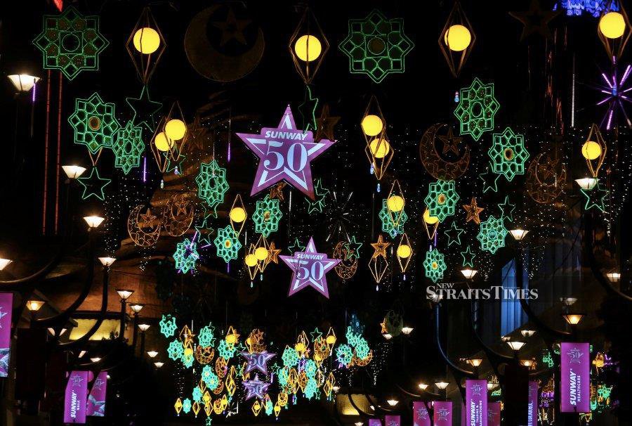 PETALING JAYA: Vibrant Hari Raya decorations, such as the star and crescent symbol festive lamp, light up the street in Bandar Sunway. - NSTP/AMRUDIN SAHIB.