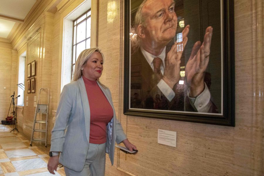 Northern Ireland's Deputy First Minister and Irish republican Sinn Fein party Northern Leader Michelle O'Neill walks past a portrait of Martin McGuinness on the Stormont Estate in Belfast, Northern Ireland. Michelle O'Neill has achieved what seemed impossible in a century of Northern Ireland's tormented history: at 47, the vice-president of Sinn Fein is preparing to become the first republican head of government of the British province. - AFP file pic