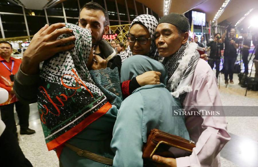 It was an emotional reunion for Nurul Ain Haron with her family members as she arrived with her Palestinian husband after being stranded in Gaza, Palestine ever since war broke out in the region over the past month. - NSTP/MOHD FADLI HAMZAH