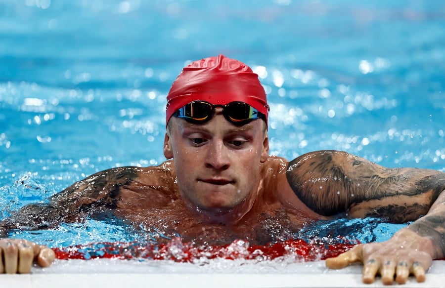 Adam Peaty of Britain reacts after the race. - REUTERS