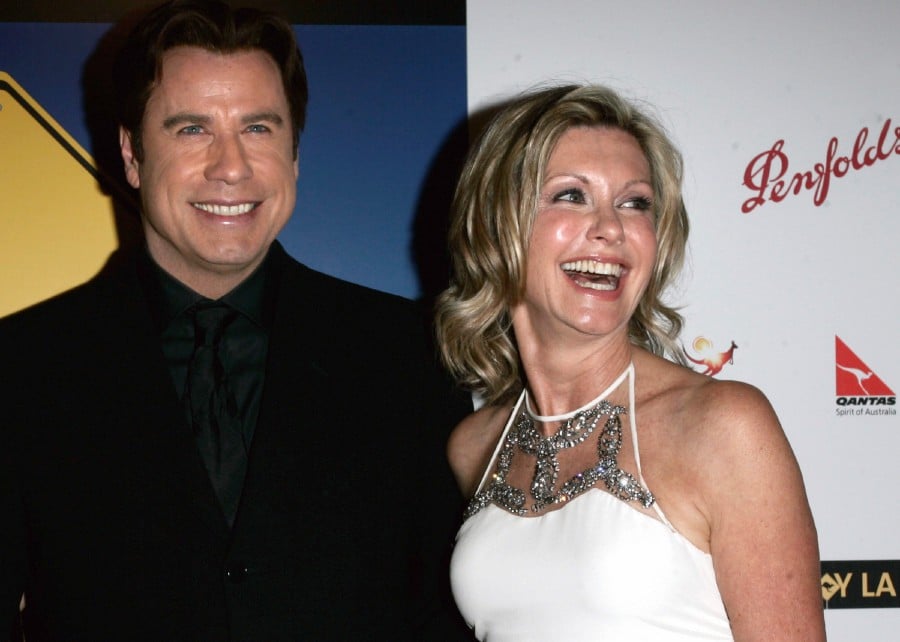 FILE - John Travolta, left, and Olivia Newton-John arrive at the The Penfolds Icon Gala Dinner in Los Angeles on Jan. 14, 2006. Travolta, who starred with Newton-John in "Grease," presented Newton-John with the "Lifetime Achievement award. Newton-John, a longtime resident of Australia whose sales topped 100 million albums, died Monday at her southern California ranch, John Easterling, her husband, wrote on Instagram and Facebook. She was 73. - AFP pic
