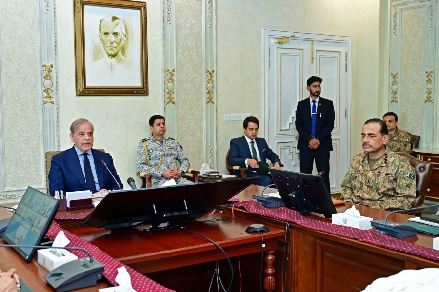 Pakistan's Prime Minister Shehbaz Sharif (left) chairs a high level security meeting with Pakistan's Army Chief General Syed Asim Munir (right) and other officials a day after a suicide attack, in Islamabad. (Photo by Pakistan Prime Minister's Office / AFP) 