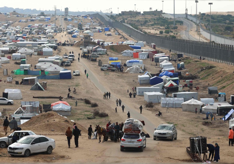 Displaced Palestinians camp near the border fence between Gaza and Egypt, on February 16, 2024 in Rafah, in the southern Gaza Strip, amid the ongoing conflict between Israel and the Palestinian Hamas group. Nearly 1.5 million displaced Palestinians are trapped in Rafah -- more than half of Gaza's populations -- seeking shelter in a sprawling makeshift encampment near the Egyptian border. AFP PIC