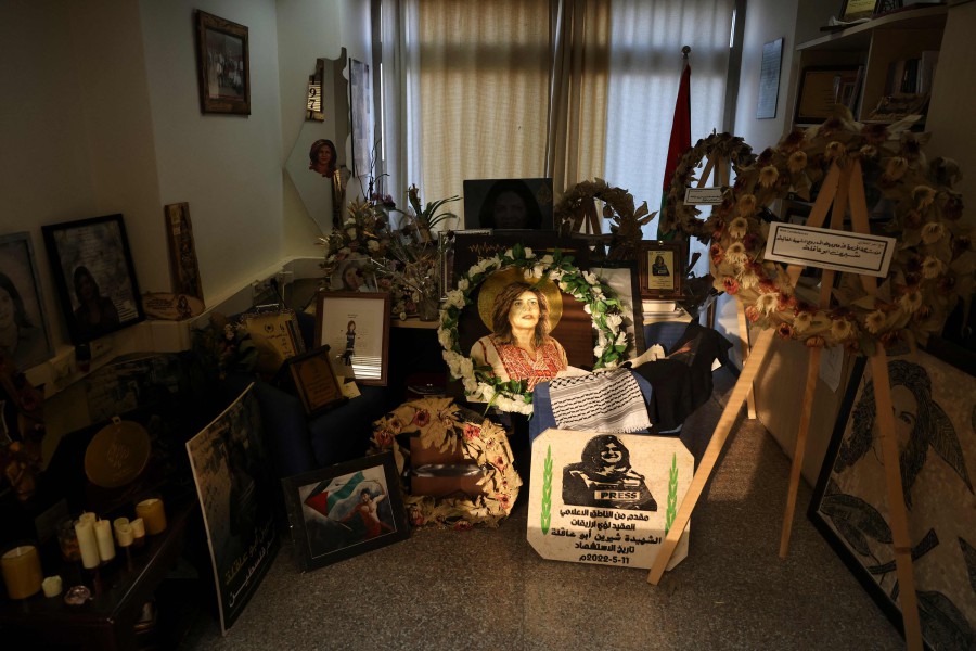 Pictures and other objects are displayed in memory of slain journalist Shireen Abu Akleh, in the room that used toi be her office at the Al Jazeera news channel, in the West Bank city of Ramallah on May 9, 2023. A year after an Israeli bullet killed Abu Akleh, her West Bank office remains almost untouched but mourners' flowers have piled up in an adjacent room. -AFP PIC