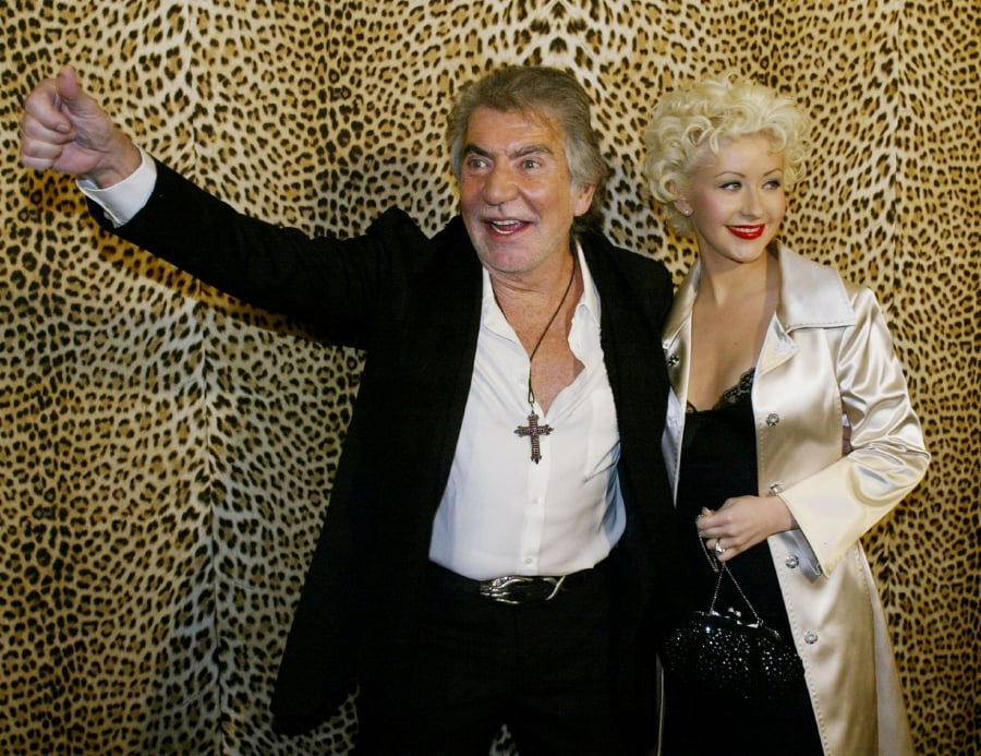 (FILE PHOTO) Singer Christina Aguilera poses with Italian fashion designer Roberto Cavalli at the opening of his Boutique in Beverly Hills. (REUTERS/Fred Prouser/File Photo)
