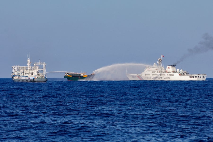 Chinese Coast Guard vessels fire water cannons towards a Philippine resupply vessel Unaizah May 4 on its way to a resupply mission at Second Thomas Shoal in the South China Sea, March 5, 2024. - REUTERS