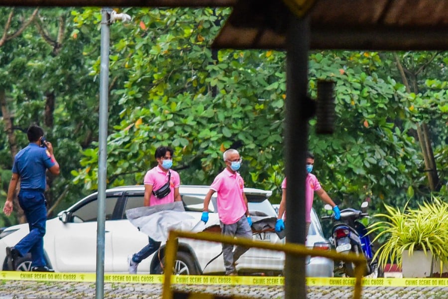 A body bag (C) is taken away from the scene after three people were killed in a shooting at Ateneo de Manila University in Quezon City, suburban Manila, on July 24, 2022. - Three people were killed July 24 in a rare shooting at a university in the Philippine capital Manila, officials said, in what appears to have been a targeted political assassination. - AFP pic