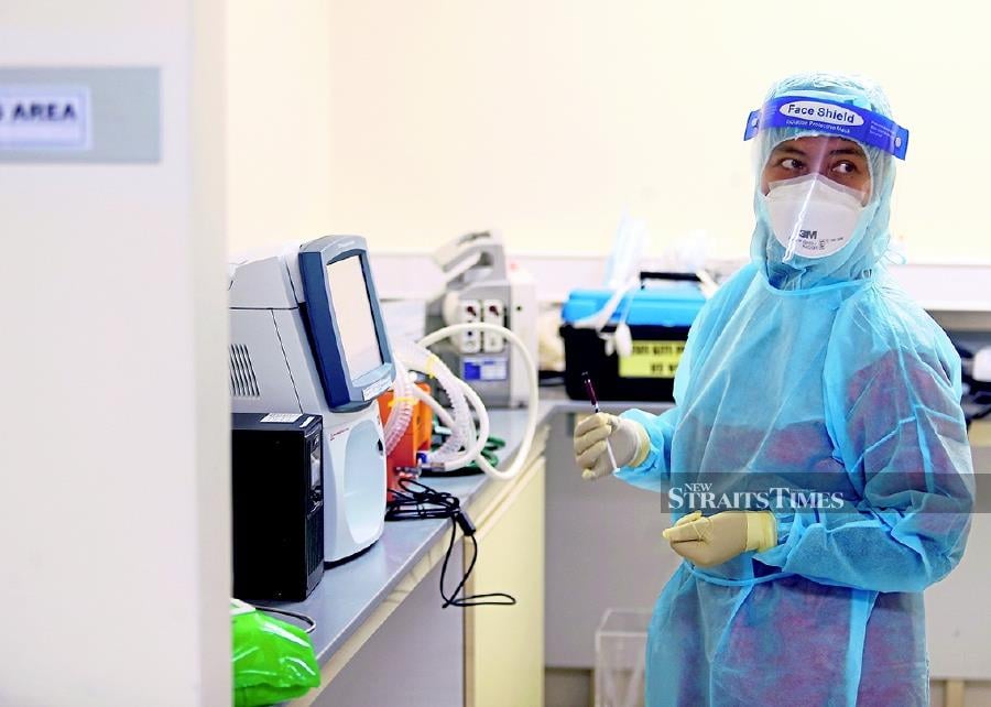 Nurse Suraida Mohd Daud holding a blood sample of a Covid-19 patient.