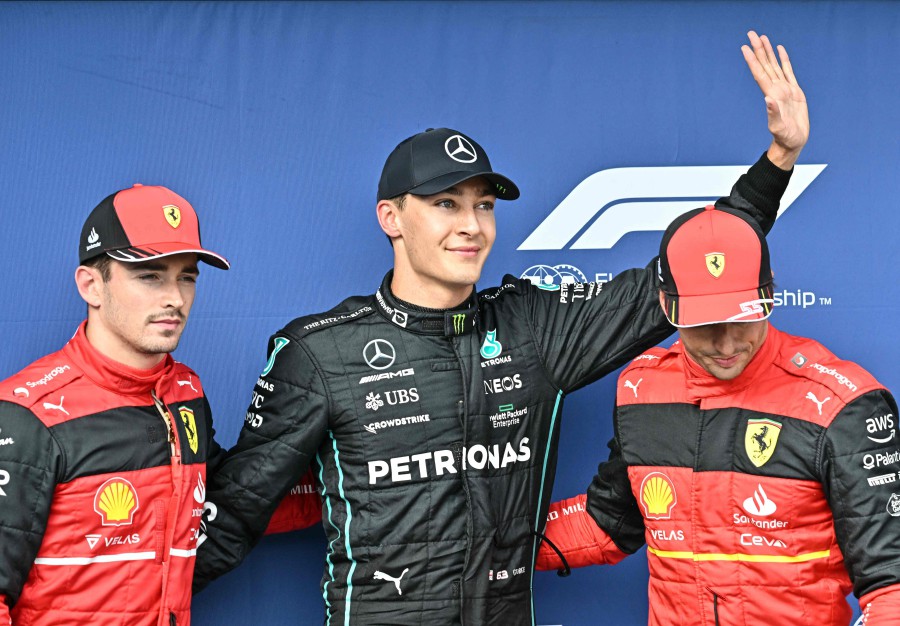 (L to R) Third placed Ferrari's Monegasque driver Charles Leclerc, first placed Mercedes' British driver George Russell and second placed Ferrari's Spanish driver Carlos Sainz Jr pose after the qualifying session ahead of the Formula One Hungarian Grand Prix at the Hungaroring in Mogyorod near Budapest, Hungary, on July 30, 2022. - AFP pic