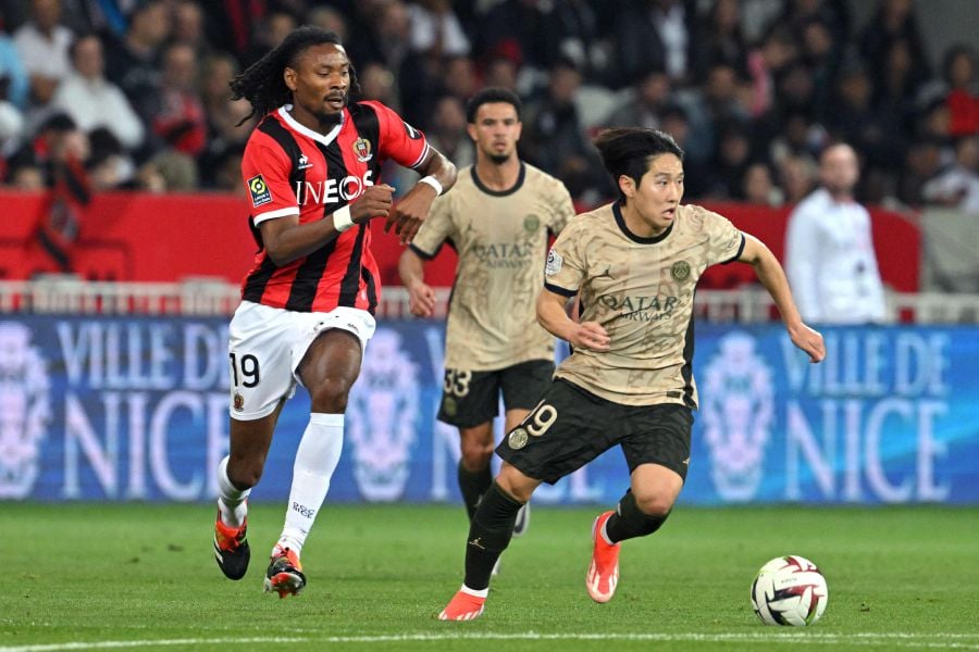 Paris Saint-Germain's South Korean midfielder Lee Kang-in (R) runs with the ball chased by Nice's French midfielder Khephren Thuram (L) during the French L1 football match between OGC Nice and Paris Saint-Germain (PSG) at the Allianz Riviera Stadium in Nice, south-eastern France. - AFP pic