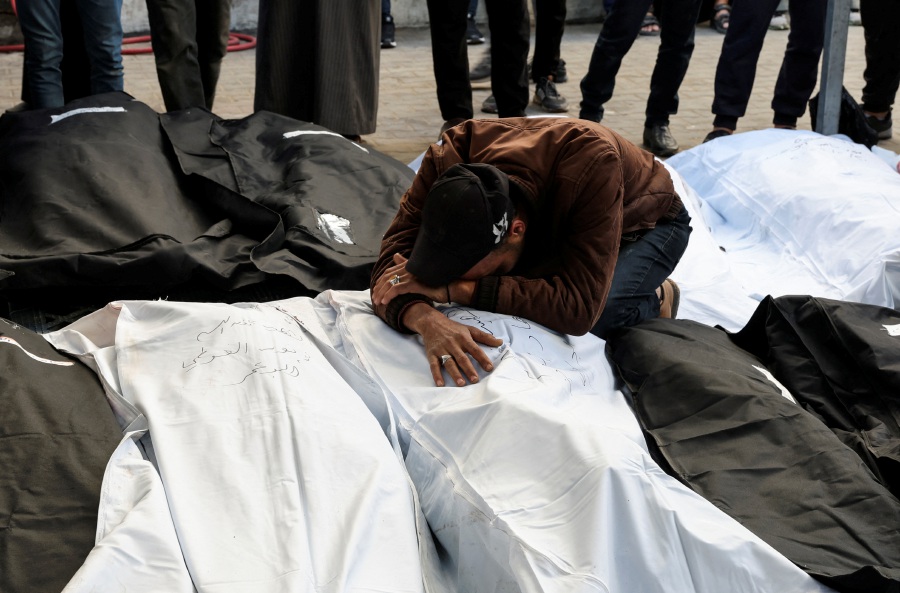 A mourner reacts near the bodies of Palestinians, most of whom were killed in Israeli strikes, amid the ongoing conflict between Israel and Hamas, at Abu Yousef Al-Najjar hospital, in Rafah, in the southern Gaza Strip. - Reuters pic