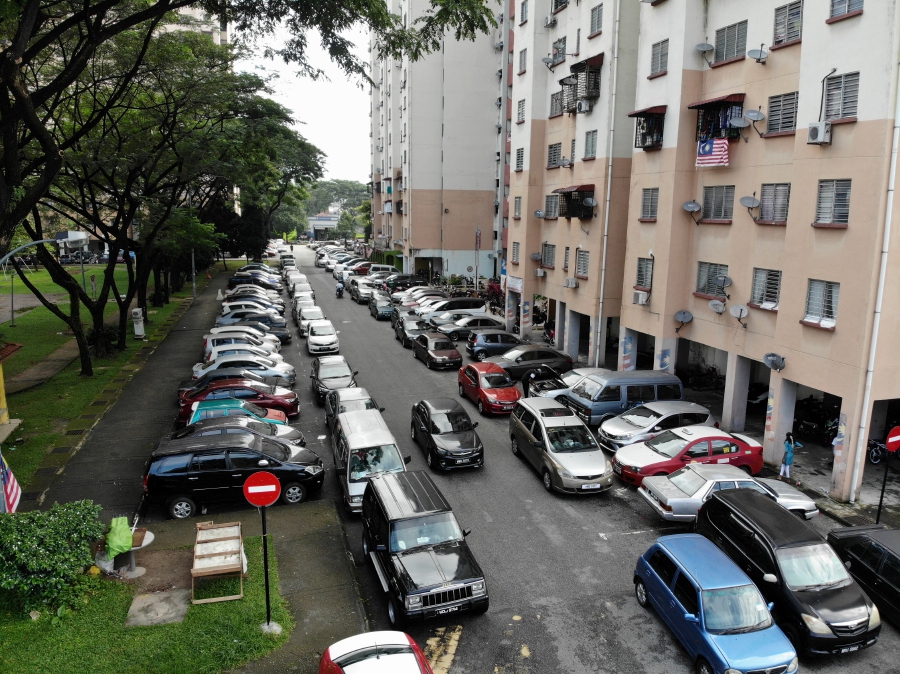 The government must review the current housing policy and guidelines for parking space allocation to ensure enough spaces and avoid illegally parked cars obstructing emergency calls, experts say. - Bernama file pic