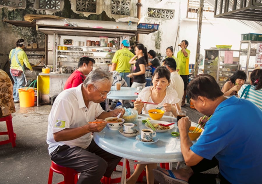 Locals savour the flavour of Penang's street food culture, where every bite tells a story of tradition and taste. - File pic credit (Penang Global Tourism)