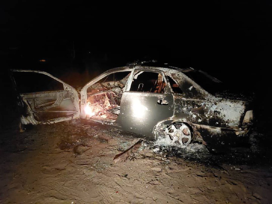 A police patrol car was completely destroyed after it was allegedly set on fire by a plantation worker at Kampung Silicon in Nenasi near here yesterday.  - NSTP/ courtesy of Fire and Rescue Dept