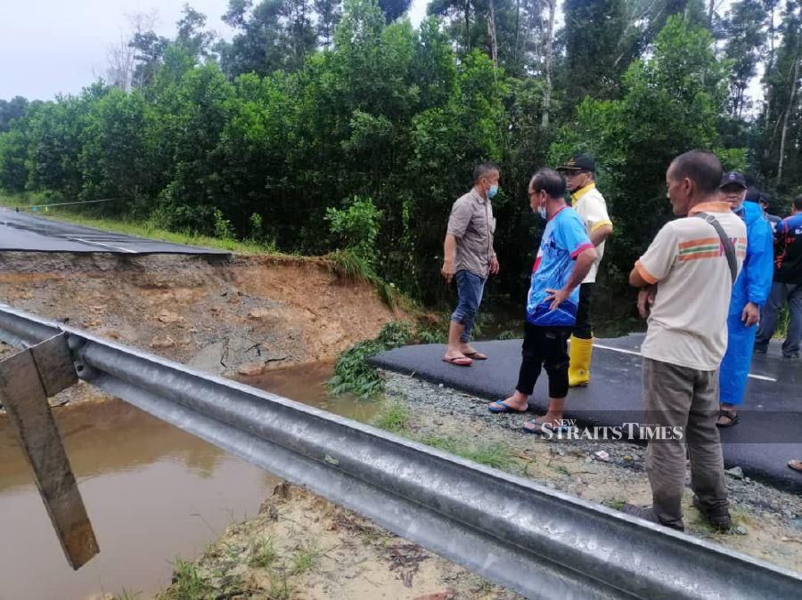 Sabah Public Works Department (JKR) director Ali Ahmad Hamid inspecting the collapsed stretch at Jalan Suang Dayang Layak in Pitas, on Friday. - Photo courtesy of Sabah JKR
