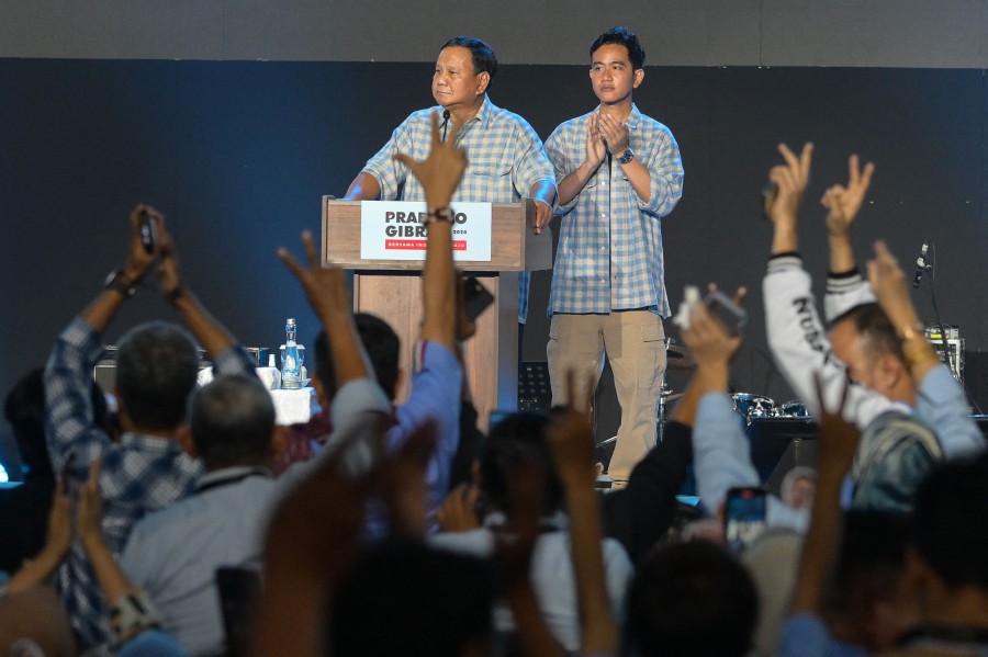 Indonesian presidential candidate Prabowo Subianto (Left) addresses supporters next to vice presidential candidate Gibran Rakabuming Raka (Right), the son of Indonesian President Joko Widodo and current Surakarta City mayor, after polls closed in the country�s presidential and legislative elections in Jakarta on Feb 14. — AFP