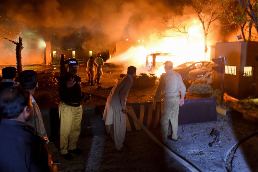 Security personnel and fire fighters arrive at the site of an explosion in Quetta. - AFP pic