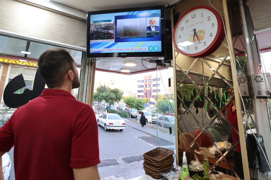  An Iranian man watches the news on TV in a restaurant in Tehran as state TV reported that a helicopter carrying Iran's president was involved in "an accident" in poor weather conditions on his way back from the province of East Azerbaijan where he inaugurated a dam project together with his Azeri counterpart yesterday (May 19). — AFP