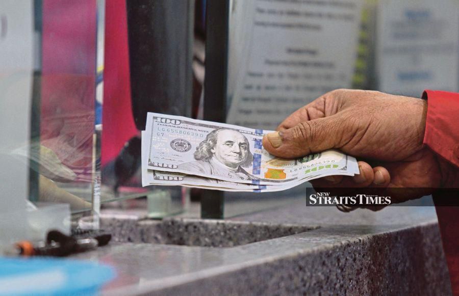 The ringgit opened lower against the US dollar on a lack of catalysts, said dealers. 