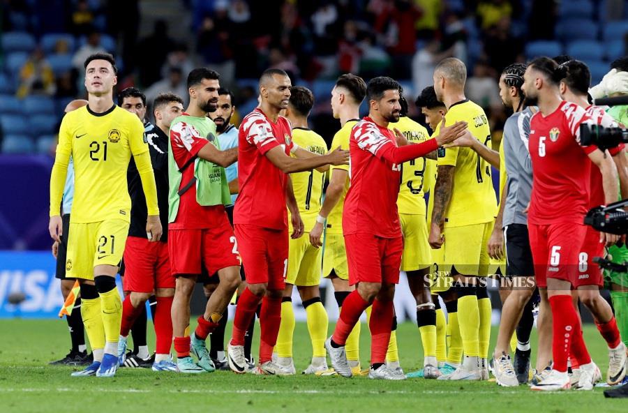 Jordan and Malaysia players shake hands after the match. - REUTERS pic