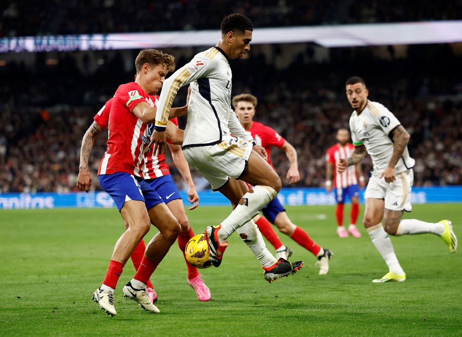 Real Madrid's Jude Bellingham in action with Atletico Madrid's Marcos Llorente. - REUTERS pic