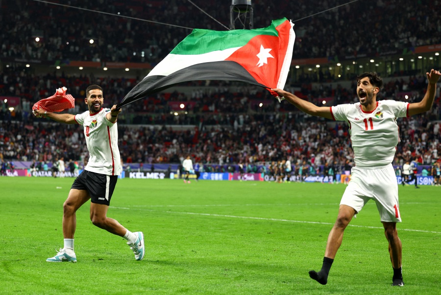 Jordan's Ali Olwan and Yazan Al Naimat celebrate after reaching the AFC Asian Cup final. - REUTERS pic