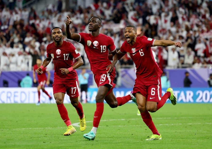 Qatar's Almoez Ali celebrates scoring their third goal with Abdulaziz Hatem. - REUTERS pic