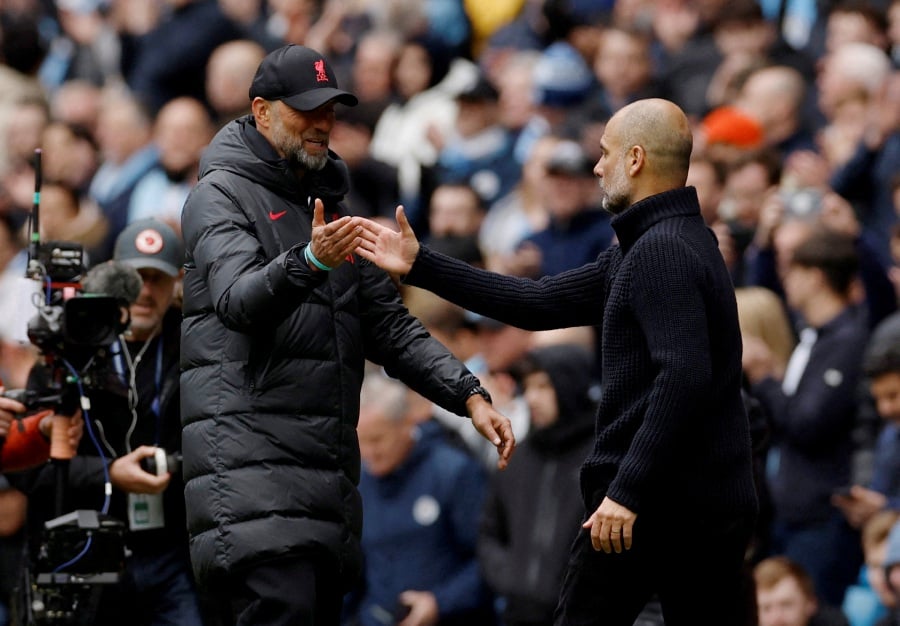 Liverpool manager Juergen Klopp shakes hands with Manchester City manager Pep Guardiola after the match. - Reuters pic