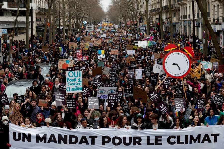 Protesters hold placards and a banner reading "A mandate for the climate" during a "Look up" march to urge governments to act against climate change and social injustice in Paris. -  REUTERS Pic