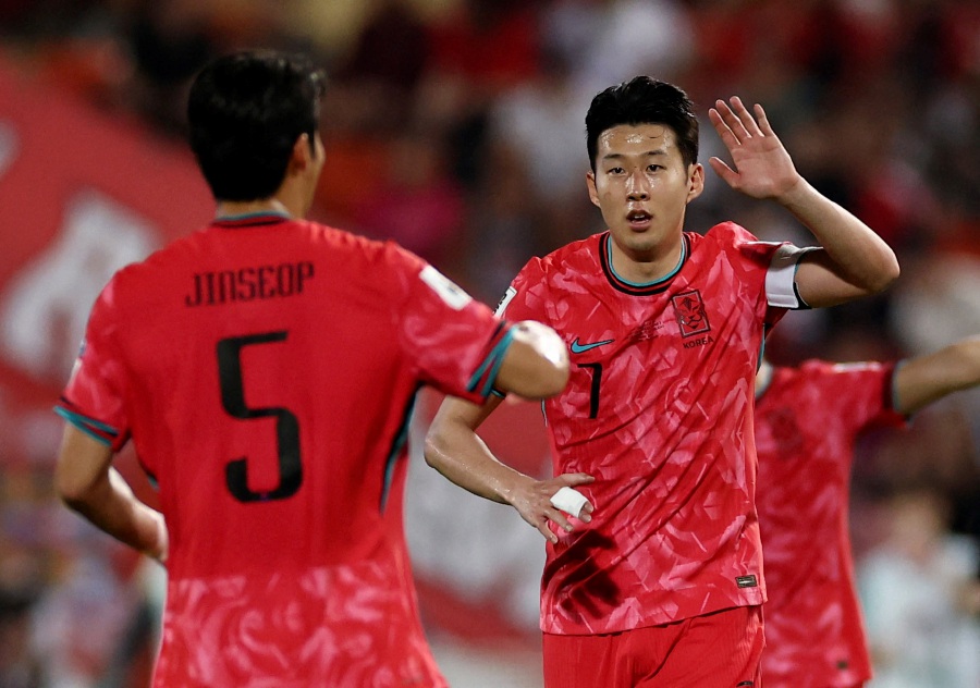 South Korea's Son Heung-min celebrates scoring their second goal with Park Jin-Seop. - REUTERS PIC