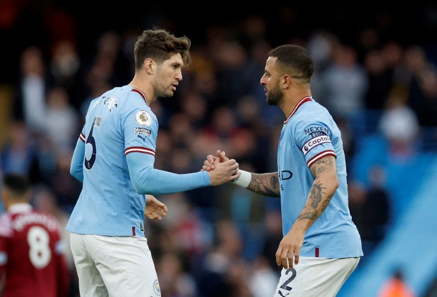 Manchester City's John Stones and Kyle Walker shakes hands before the match. - Reuters pic