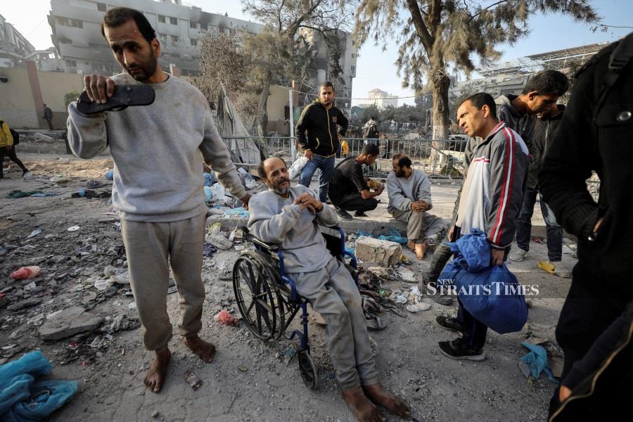A man sits in a wheelchair as Palestinians inspect the damages at Al Shifa Hospital after Israeli forces withdrew from the hospital and the area around it following a two-week operation, amid the ongoing conflict between Israel and Hamas, in Gaza City April 1, 2024.- REUTERS pic