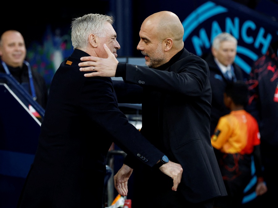Manchester City manager Pep Guardiola shakes hands with Real Madrid coach Carlo Ancelotti before the match. - Reuters pic